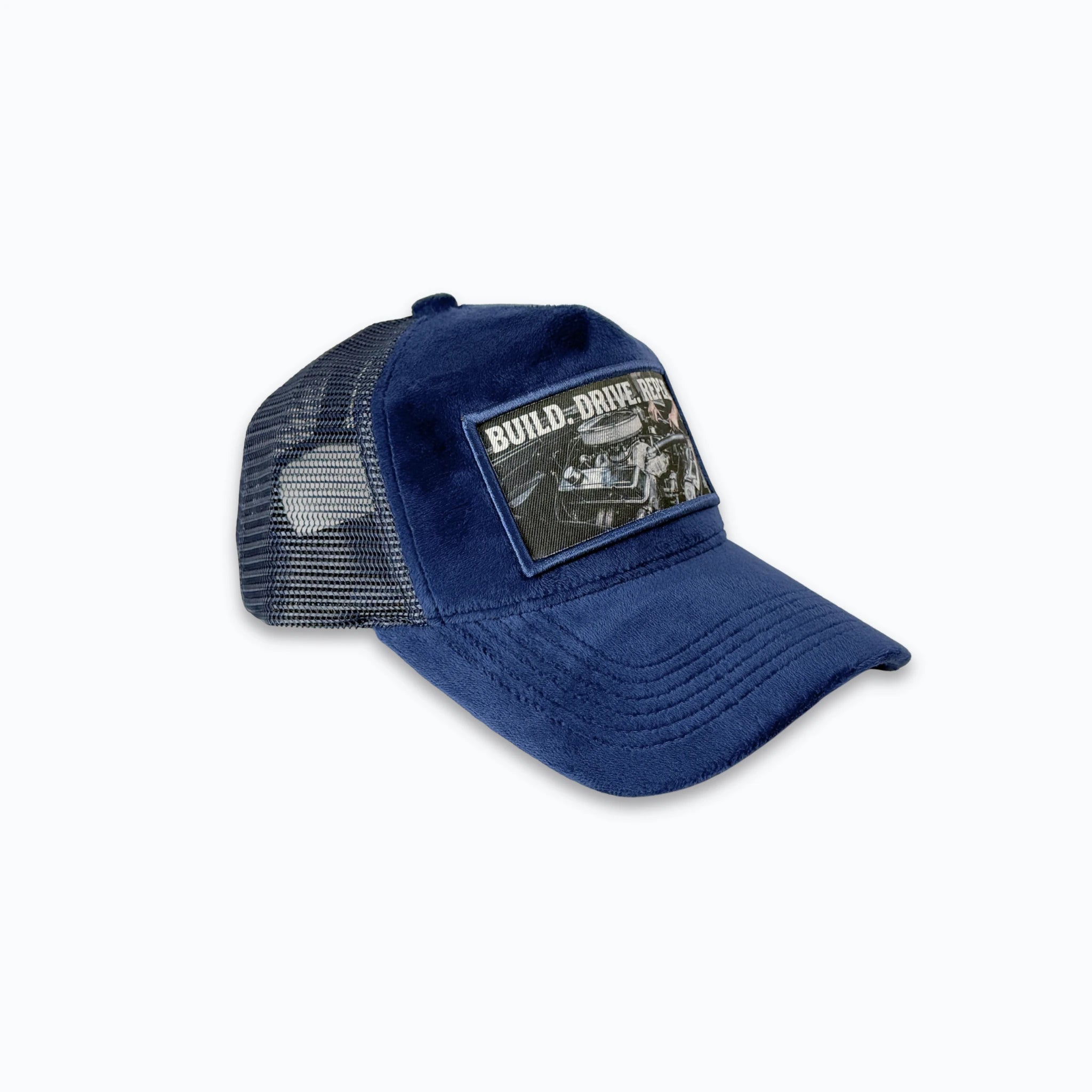 Profilbild av mörkblå velvet truckerkeps med matchande nätbaksida. Premium keps med tryck och bilmotiv för en stark Motor & Racing-look.