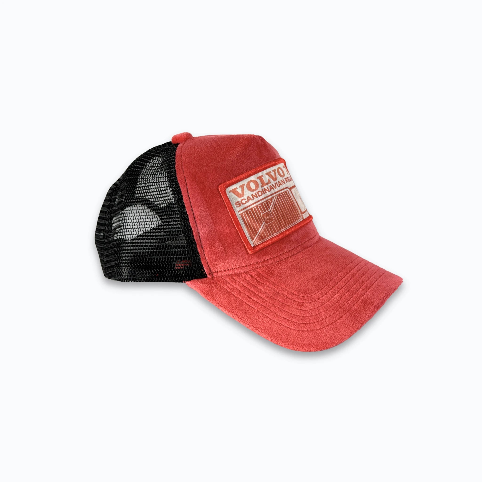 Profilbild av röd velvet truckerkeps med svart nätbaksida och XVERA logotyp i metall. Premium keps med tryck perfekt för svensk motorkultur och raggare.