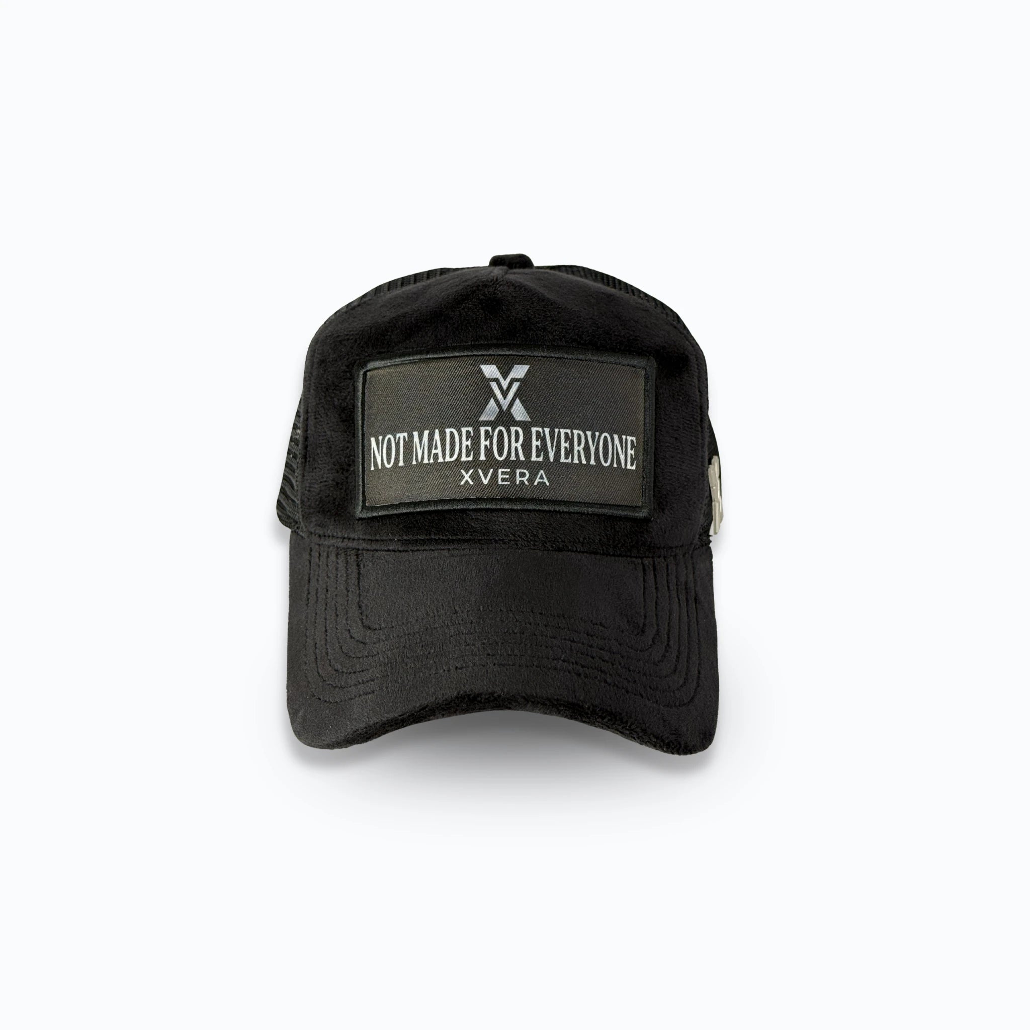 Svart velvet keps framifrån med en stilren patch och den vita texten NOT MADE FOR EVERYONE. Exklusiv statement truckerkeps från varumärket XVERA.